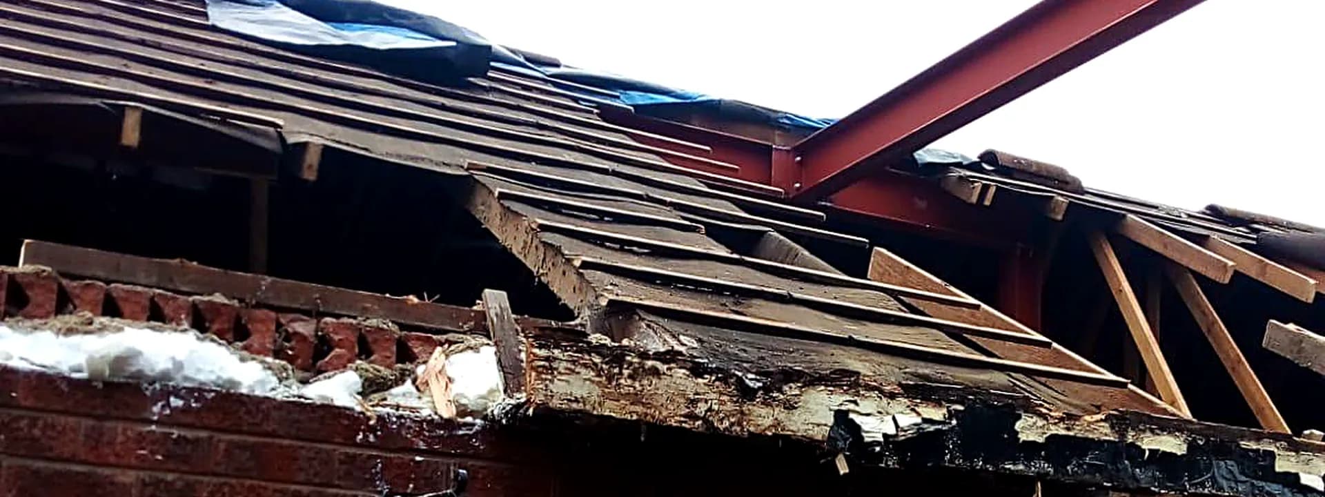 Exposed roof timbers and a new steel beam during a structural alteration
