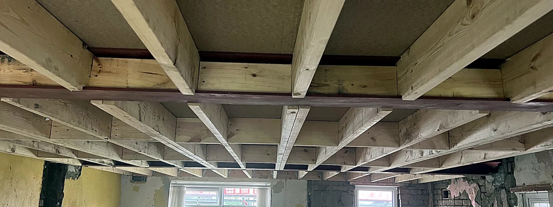 New timber floor joists carried on steel beams during a structural alteration